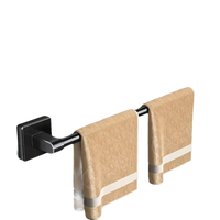 Black metal towel rack with two beige towels.