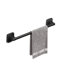 Black metal towel bar with gray towel.