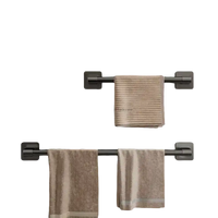Two dark metal towel bars with towels.