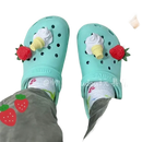 Mint-green clogs with strawberry and ice cream cone charms.