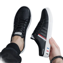 Black and white slip-on sneakers.