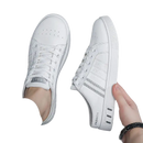 White slip-on sneakers.