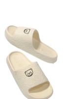 Cream-colored bear-themed platform sandals.