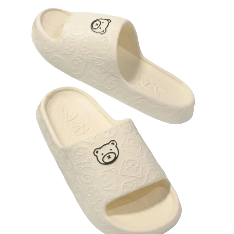 Cream-colored bear-themed slide sandals.