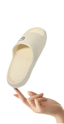 Cream-colored slipper with a cartoon face.