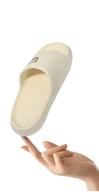 Cream-colored slipper with a cartoon face.