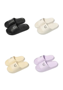 Four pairs of cartoon-emblazoned slippers.