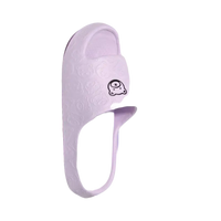 Lavender slipper with cartoon face.