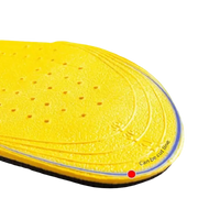 Yellow shoe insole with perforations.