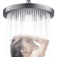 Overhead shower head with water.