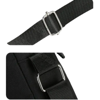 Black bag strap with metal hardware.