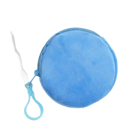 Round, light blue, plush coin purse with zipper and loop.