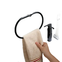 Black towel ring with beige towel.