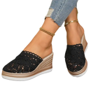 Black lace wedge mules.
