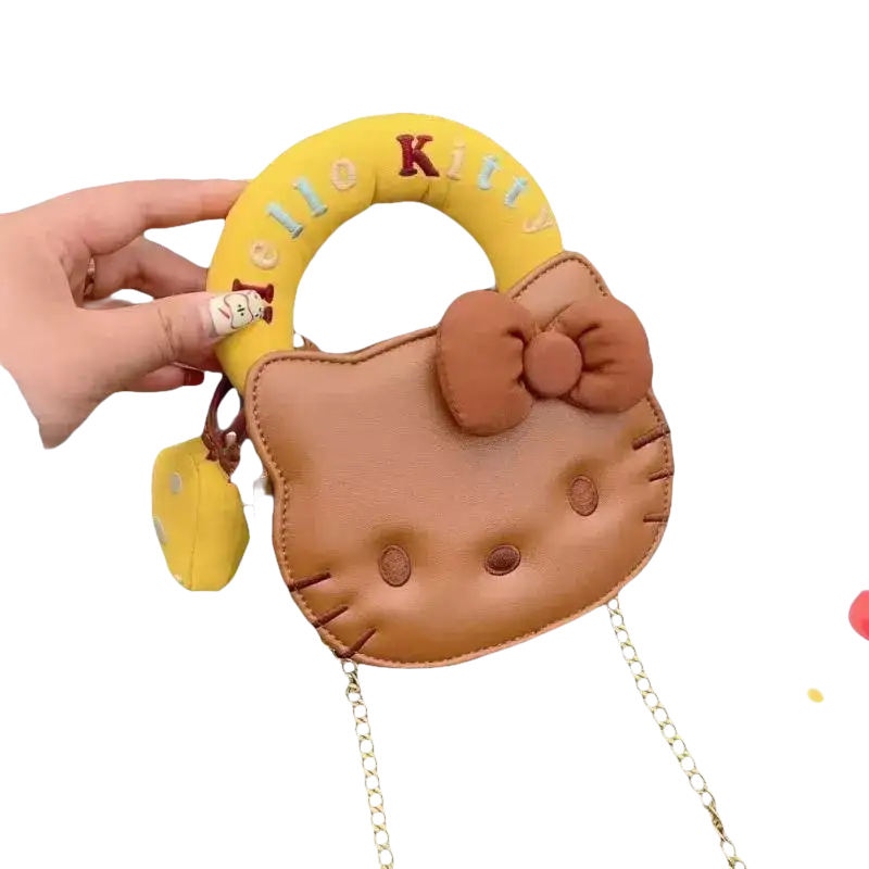 Brown Hello Kitty purse with yellow handle.