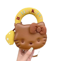 Brown Hello Kitty purse with yellow handle.