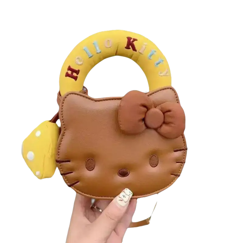 Brown Hello Kitty purse with yellow handle.