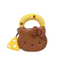 Brown Hello Kitty purse with yellow handle and mushroom charm.