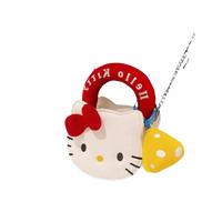 Hello Kitty purse with mushroom charm.