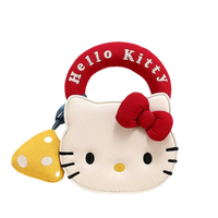 Hello Kitty purse with mushroom charm.