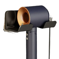 Wall-mounted hair dryer holder.