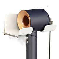 Wall-mounted hair dryer holder.