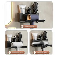 Wall-mounted hair dryer holder with compartments.