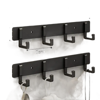 Black four-hook wall rack.