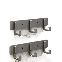 Silver-colored, three-hook wall rack.