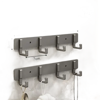 Silver four-hook wall rack.