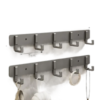 Silver-colored, five-hook wall-mounted racks.