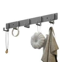 Gray wall-mounted coat rack with hanging accessories.