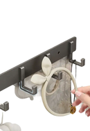 Wall-mounted metal hook rack.