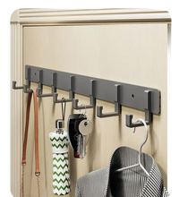 Gray wall-mounted coat rack with multiple hooks.