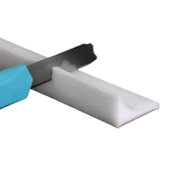 White adhesive-backed plastic strip being cut.