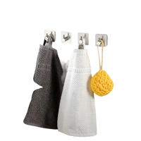 Bathroom towels and sponge on hooks.