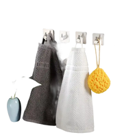 Bathroom towels and sponge on hooks.