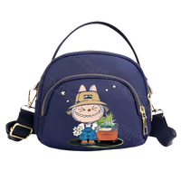 Navy blue cartoon-adorned handbag.