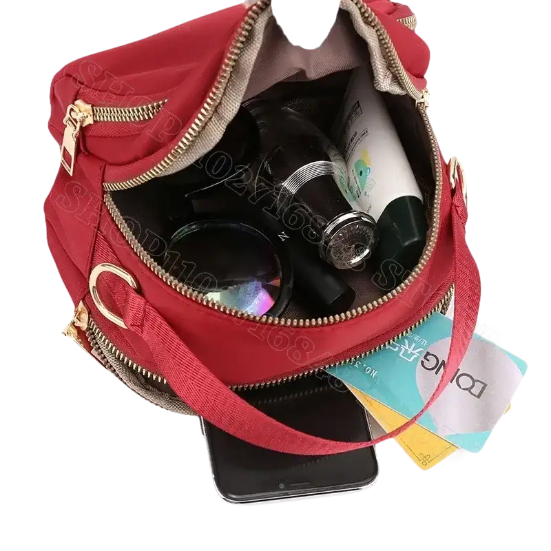 Red nylon handbag with contents.