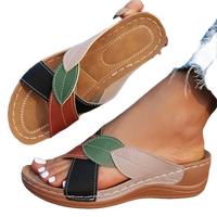 Women’s leaf-accented slide sandals.