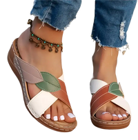 Leaf-accented crisscross sandals.