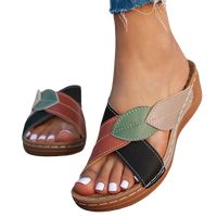 Leaf-accented crisscross sandals.