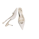 Pair of white, pointed-toe slingback heels.