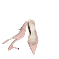 Pair of pink patent leather slingback heels.