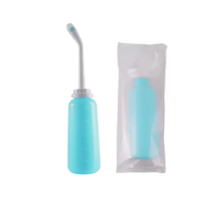 Turquoise portable bidet with angled nozzle.