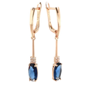 Rose gold earrings with blue gemstones.