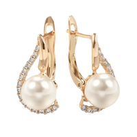 Gold-tone pearl drop earrings.