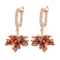 Pair of rose gold maple leaf earrings.