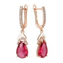Rose gold earrings with ruby teardrops and diamond accents.
