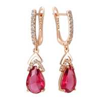 Rose gold earrings with ruby teardrops and diamond accents.